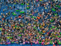 A large number of citizens are cooling off at a water park on the evening of high temperature in Nanjing, China, on July 6, 2024. (