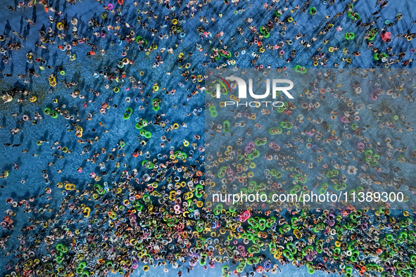 A large number of citizens are cooling off at a water park on the evening of high temperature in Nanjing, China, on July 6, 2024. 