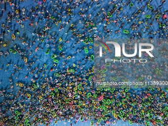 A large number of citizens are cooling off at a water park on the evening of high temperature in Nanjing, China, on July 6, 2024. (