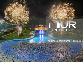 A large number of citizens are watching a fireworks show at a water park during high temperatures in Nanjing, China, on July 6, 2024. (