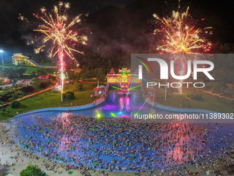 A large number of citizens are watching a fireworks show at a water park during high temperatures in Nanjing, China, on July 6, 2024. (