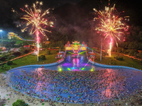 A large number of citizens are watching a fireworks show at a water park during high temperatures in Nanjing, China, on July 6, 2024. (