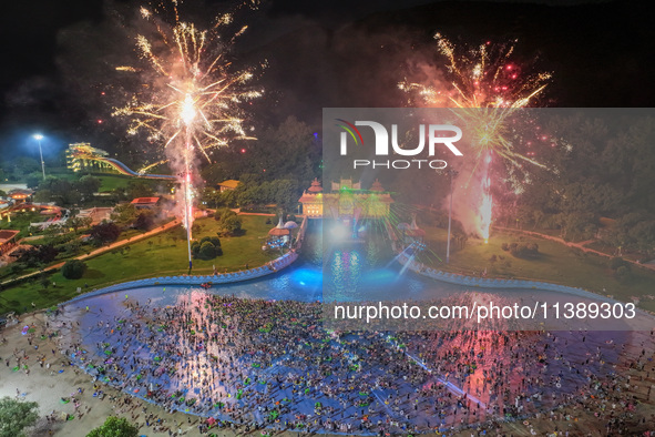 A large number of citizens are watching a fireworks show at a water park during high temperatures in Nanjing, China, on July 6, 2024. 