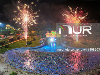 A large number of citizens are watching a fireworks show at a water park during high temperatures in Nanjing, China, on July 6, 2024. (