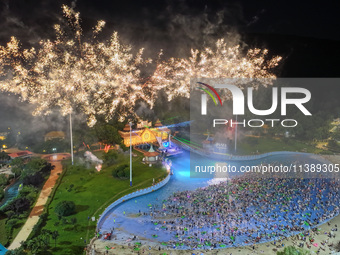 A large number of citizens are watching a fireworks show at a water park during high temperatures in Nanjing, China, on July 6, 2024. (