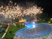 A large number of citizens are watching a fireworks show at a water park during high temperatures in Nanjing, China, on July 6, 2024. (