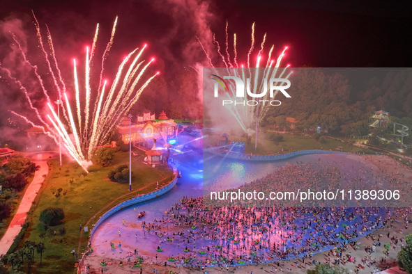 A large number of citizens are watching a fireworks show at a water park during high temperatures in Nanjing, China, on July 6, 2024. 