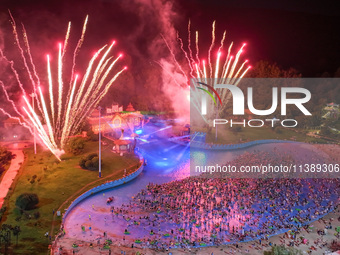 A large number of citizens are watching a fireworks show at a water park during high temperatures in Nanjing, China, on July 6, 2024. (