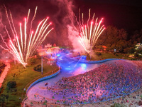 A large number of citizens are watching a fireworks show at a water park during high temperatures in Nanjing, China, on July 6, 2024. (