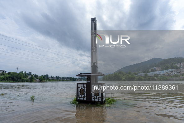 A gate is opening to release floodwater at a power station in Enshi, Hubei province, China, on July 6, 2024. 