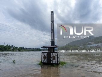 A gate is opening to release floodwater at a power station in Enshi, Hubei province, China, on July 6, 2024. (