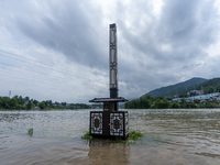 A gate is opening to release floodwater at a power station in Enshi, Hubei province, China, on July 6, 2024. (