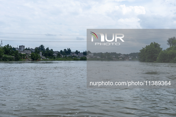 A gate is opening to release floodwater at a power station in Enshi, Hubei province, China, on July 6, 2024. 