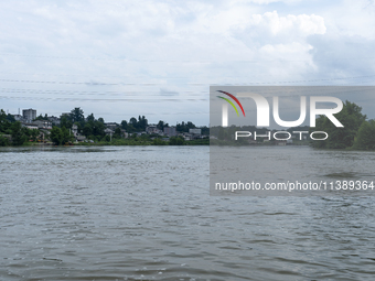 A gate is opening to release floodwater at a power station in Enshi, Hubei province, China, on July 6, 2024. (