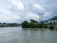 Security guards are patrolling the water as a power plant is opening a gate to release floodwater in Enshi, Hubei province, China, on July 6...