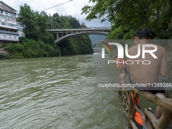 A gate is opening to release floodwater at a power station in Enshi, Hubei province, China, on July 6, 2024. (