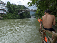 A gate is opening to release floodwater at a power station in Enshi, Hubei province, China, on July 6, 2024. (