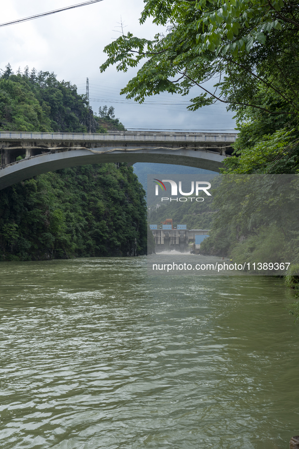 A gate is opening to release floodwater at a power station in Enshi, Hubei province, China, on July 6, 2024. 