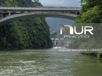 A gate is opening to release floodwater at a power station in Enshi, Hubei province, China, on July 6, 2024. (