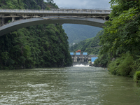 A gate is opening to release floodwater at a power station in Enshi, Hubei province, China, on July 6, 2024. (