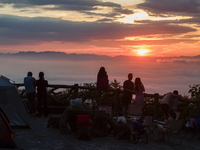 Tourists are watching the sunrise from a viewing platform over the Three Gorges in Yichang, China, on July 7, 2024. (