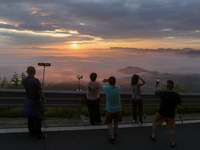 Tourists are watching the sunrise from a viewing platform over the Three Gorges in Yichang, China, on July 7, 2024. (