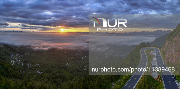 Tourists are watching the sunrise from a viewing platform over the Three Gorges in Yichang, China, on July 7, 2024. 