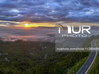 Tourists are watching the sunrise from a viewing platform over the Three Gorges in Yichang, China, on July 7, 2024. (