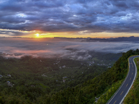 Tourists are watching the sunrise from a viewing platform over the Three Gorges in Yichang, China, on July 7, 2024. (