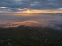 Tourists are watching the sunrise from a viewing platform over the Three Gorges in Yichang, China, on July 7, 2024. (