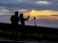 Tourists are watching the sunrise from a viewing platform over the Three Gorges in Yichang, China, on July 7, 2024. (