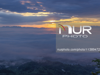 Tourists are watching the sunrise from a viewing platform over the Three Gorges in Yichang, China, on July 7, 2024. (