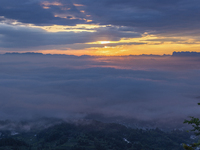 Tourists are watching the sunrise from a viewing platform over the Three Gorges in Yichang, China, on July 7, 2024. (