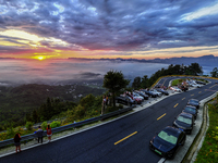 Tourists are watching the sunrise from a viewing platform over the Three Gorges in Yichang, China, on July 7, 2024. (