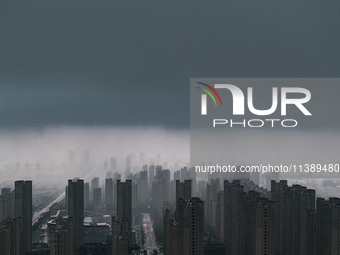 The city of Lianyungang is being covered by dark clouds in Lianyungang, China, on July 7, 2024. (