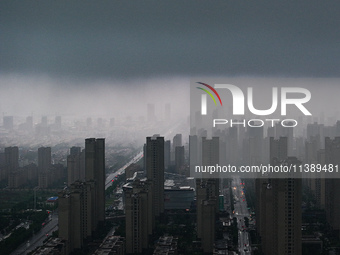 The city of Lianyungang is being covered by dark clouds in Lianyungang, China, on July 7, 2024. (