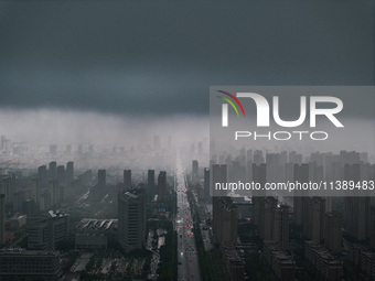 The city of Lianyungang is being covered by dark clouds in Lianyungang, China, on July 7, 2024. (