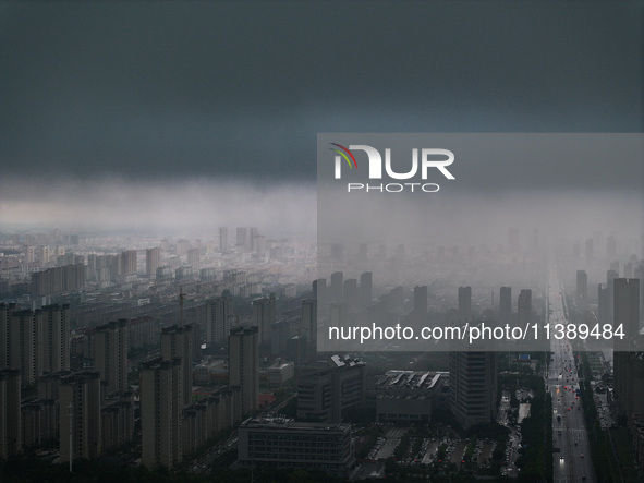 The city of Lianyungang is being covered by dark clouds in Lianyungang, China, on July 7, 2024. 