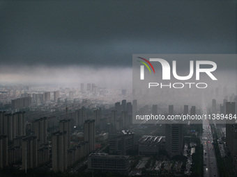 The city of Lianyungang is being covered by dark clouds in Lianyungang, China, on July 7, 2024. (