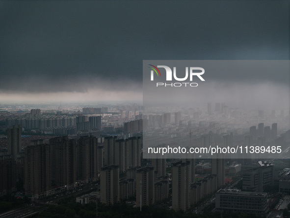 The city of Lianyungang is being covered by dark clouds in Lianyungang, China, on July 7, 2024. 