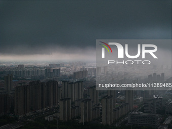 The city of Lianyungang is being covered by dark clouds in Lianyungang, China, on July 7, 2024. (