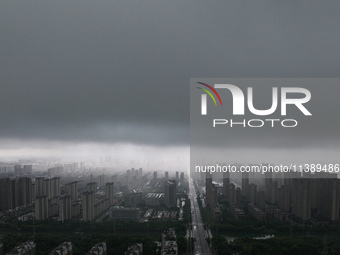 The city of Lianyungang is being covered by dark clouds in Lianyungang, China, on July 7, 2024. (