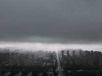 The city of Lianyungang is being covered by dark clouds in Lianyungang, China, on July 7, 2024. (