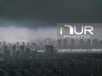 The city of Lianyungang is being covered by dark clouds in Lianyungang, China, on July 7, 2024. (