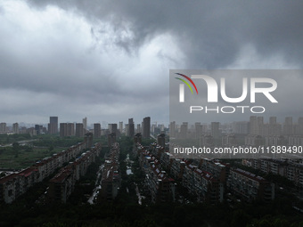 The city of Lianyungang is being covered by dark clouds in Lianyungang, China, on July 7, 2024. (