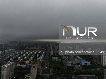 The city of Lianyungang is being covered by dark clouds in Lianyungang, China, on July 7, 2024. (