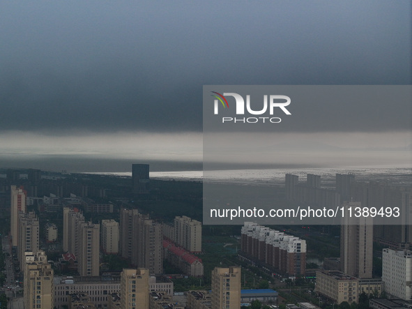 The city of Lianyungang is being covered by dark clouds in Lianyungang, China, on July 7, 2024. 