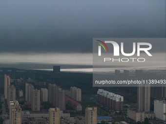 The city of Lianyungang is being covered by dark clouds in Lianyungang, China, on July 7, 2024. (