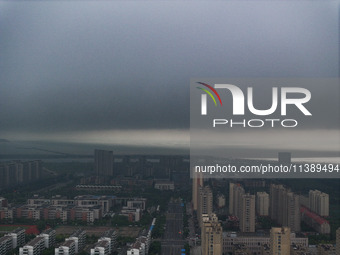 The city of Lianyungang is being covered by dark clouds in Lianyungang, China, on July 7, 2024. (