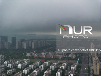 The city of Lianyungang is being covered by dark clouds in Lianyungang, China, on July 7, 2024. (